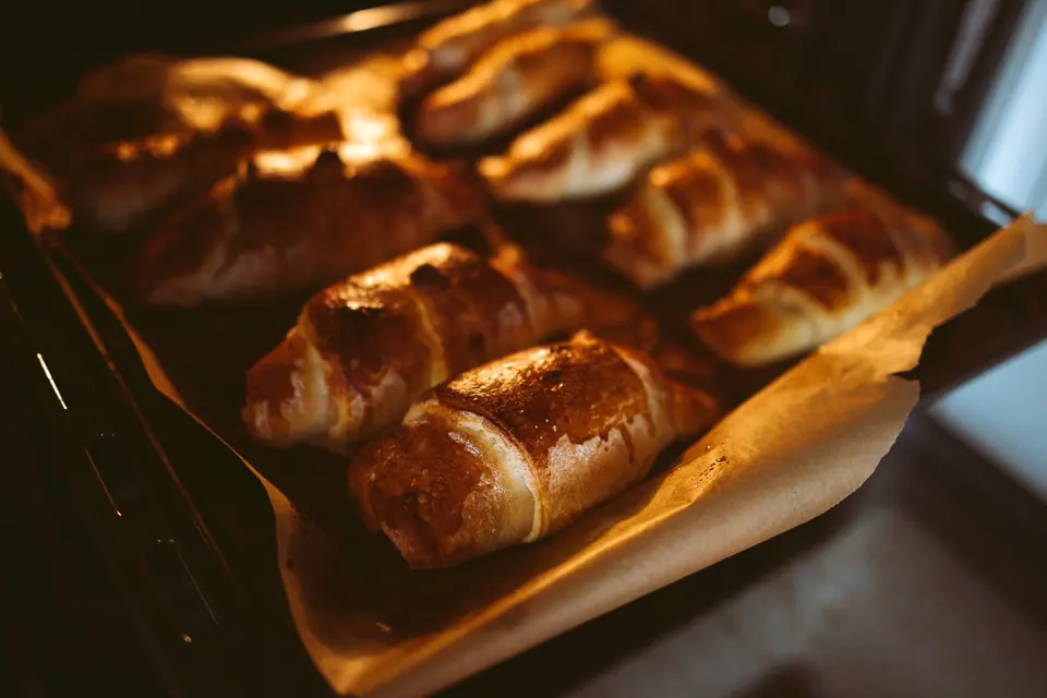Croissants baking in a glowing oven